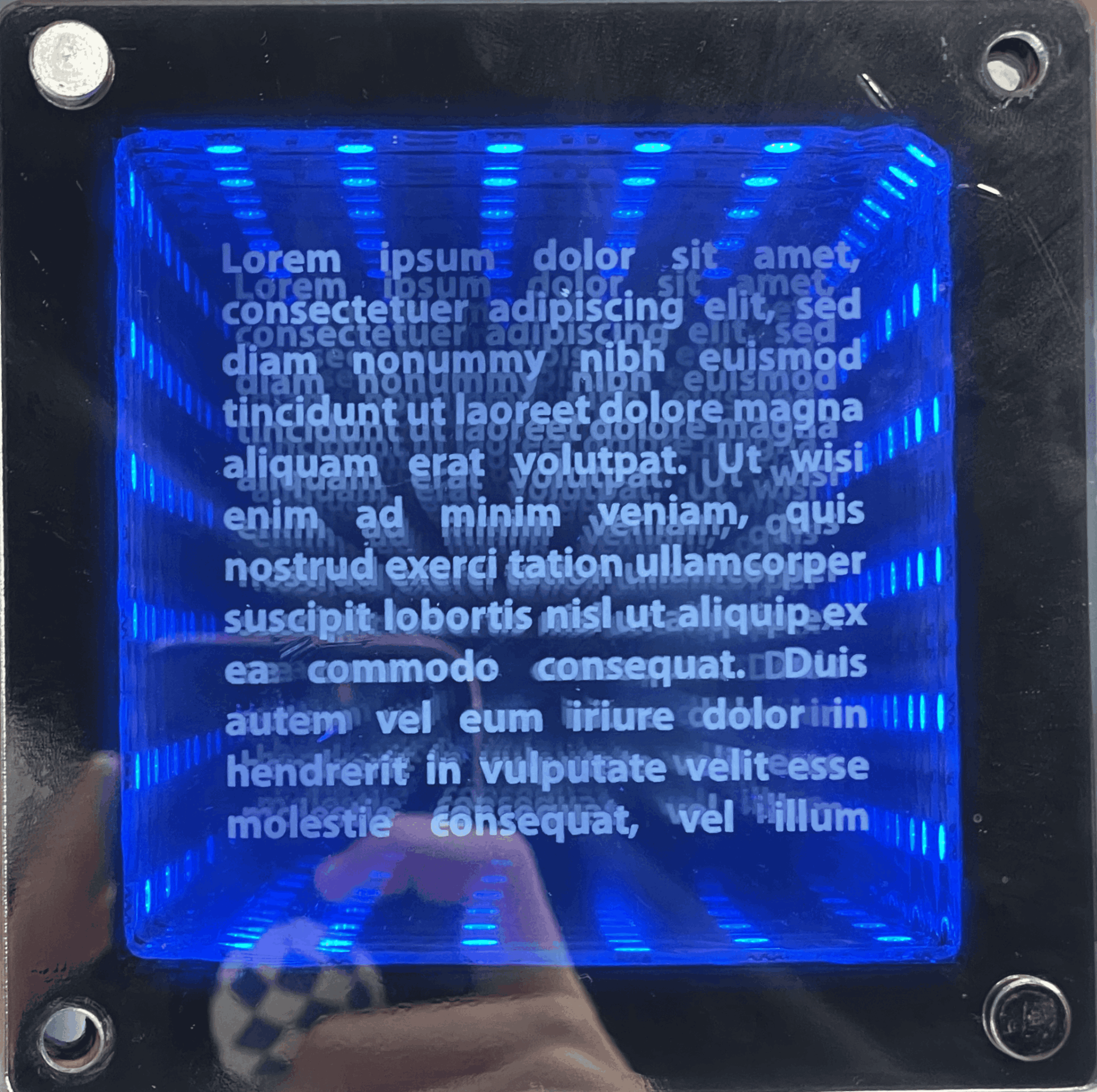 A small-scale square prototype made by layering one-way and etched mirrored acrylic, side- and back-lit by LED strips